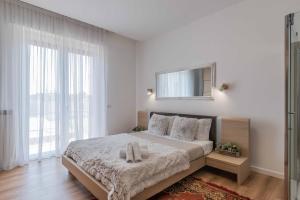 a bedroom with a large bed with a mirror on the wall at Luxury apartment Malpensa in Cardano al Campo