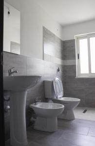 a bathroom with a toilet and a sink at LUMNIK - Hotel & Apartments in Lezhë