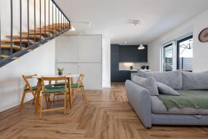 a living room and dining room with a table and a couch at Villa NiA ZadarVillas in Nin