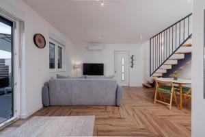 a living room with a couch and a table at Villa NiA ZadarVillas in Nin