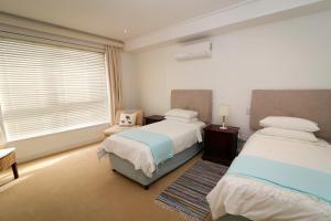 Ένα ή περισσότερα κρεβάτια σε δωμάτιο στο Hermanus Seaview Apartment