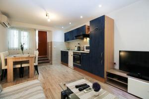 a large living room with a kitchen and a living room at Apartment Besima 2178 in Pula