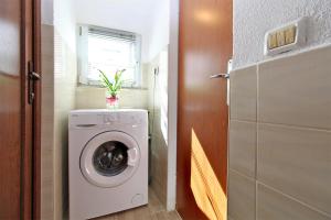 a washer and dryer in a small bathroom at Apartment Besima 2178 in Pula