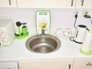 a kitchen counter with a sink in a kitchen at City Rooms in Budapest