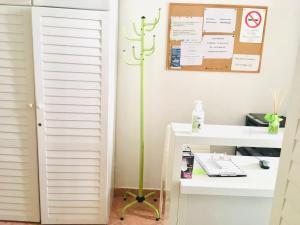 a room with a desk and a plant on the wall at City Rooms in Budapest