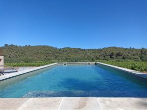 a swimming pool with a view of the mountains at Sous Les Pins gîtes et chambres d'hôtes in La Londe-les-Maures