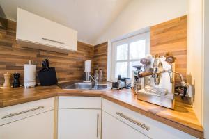 a kitchen with a counter top with a mixer at Leuchtturmhaus 1888 EG Wohnung in Borkum +7 photos