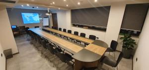 a conference room with a long table and chairs at SU Hotel in Ohrid