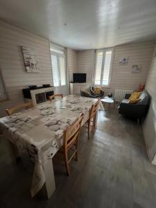 a living room with a large table and chairs at APPARTEMENT 4 PERSONNES CLASSE 2 ETOILES LEBOUCQ Laurent in Fort-Mahon-Plage