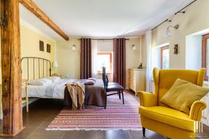 sypialnia z łóżkiem, krzesłem i kanapą w obiekcie Miętowe Wzgórze B&B w mieście Sucha