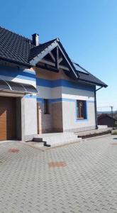 a small house with a blue and white at Pokoje Gościnne Alicja in Wicie