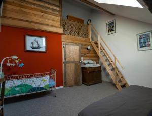 a bedroom with a staircase and a room with a bed at Au Pont Vert in Fontaine-Française