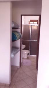 a bathroom with a toilet and a sink and a room with a toilet at Chalés Do Sol in Boracéia +27 photos