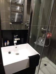a bathroom with a white sink and a shower at Superbe Studio in Cannes 450m sea & parking in Cannes