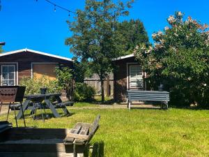 a park with a picnic table and a bench at Olle Holiday house in Ventspils