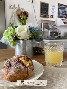 a pastry sitting on a table with a vase of flowers at Don Giacchì Country House in Catanzaro Lido