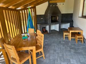 a dining room with a table and a fireplace at Relax House in Praid