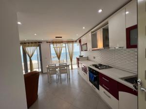 a kitchen with a table and some chairs in it at Luxury sea view duplex in Durrës