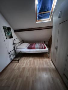 a small bedroom with a bed and a window at APPARTEMENT 6 PERSONNES CLASSE 2 ETOILES LEBOUCQ Laurent in Fort-Mahon-Plage