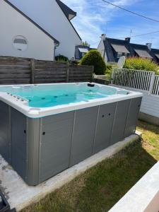 a hot tub in the backyard of a house at The Cuban & SPA Privé in Perros-Guirec
