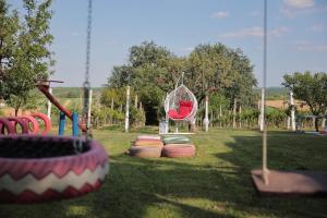 a park with a playground with a swing at Apartment Amigo in Sirova Katalena