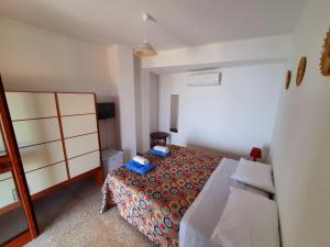 a small bedroom with a bed and a chair at Da Alfonsina in Castellabate +27 photos