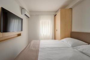 Ein Bett oder Betten in einem Zimmer der Unterkunft Hotel Delfin