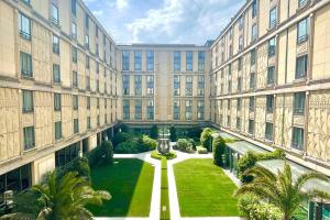 una vista exterior de un gran edificio con un patio en Hotel du Collectionneur en París