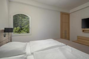 Ein Bett oder Betten in einem Zimmer der Unterkunft Hotel Delfin
