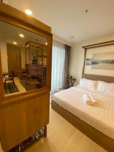 a bedroom with a large bed and a mirror at The Jomvacay Place in Kuantan