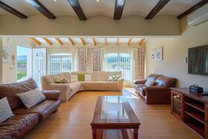 a living room with leather couches and a coffee table at Villa Esther in Jávea