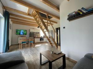 a living room with a couch and a table at Domek nad Stawem in Kłodzko