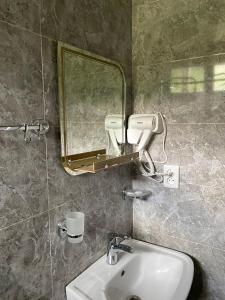 a bathroom with a sink and a mirror at Dato Khetaguri Apartment in Kazbegi +28 photos
