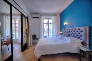 a bedroom with a large bed with a blue wall at Superbe 3 pieces Moderne et tres Central A2B233 in Cannes