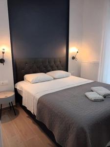 a bedroom with a large bed with white sheets and pillows at Partcon Apartment B in Neoi Epivates