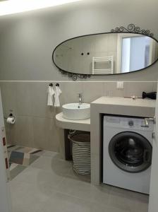 a bathroom with a washing machine and a sink at Partcon Apartment B in Neoi Epivates