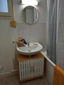 a bathroom with a sink and a mirror at Appart plein centre, balcon, 4 personnes in Sedan