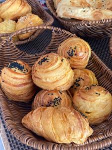 a bunch of pastries in a wicker basket at Seven Rooms Boutique Hotel in Baku