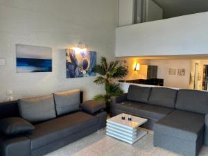 a living room with a couch and a coffee table at Apartments Stara Baska in Stara Baška