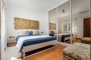 a bedroom with a large bed and a mirror at Villa Mateus in Alvor +21 photos