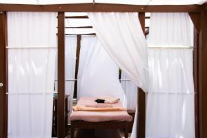 a bedroom with a bed with white curtains at Grande Albergo Delle Rose in Rhodes Town