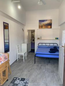 1 dormitorio con 1 cama azul en una habitación en Favignana: La porta sul mare en Favignana