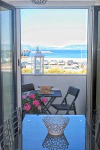 a balcony with a table and a view of the ocean at tommy house in Calasetta +44 photos