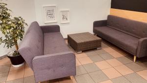 a living room with two couches and a couch at Totalenergies Frit Autentic Habay-la-Neuve in Habay-la-Neuve