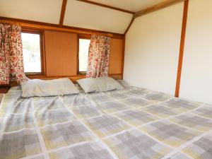 a large bed in a room with two pillows at Hawthorn Hut in Llanidloes