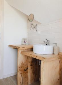 a bathroom with a sink on a wooden counter at Kubiczówka in Kopalino