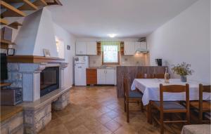 a kitchen and dining room with a table and a fireplace at Lovely Home In Liznjan With Wifi in Ližnjan