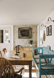 a dining room with a wooden table and chairs at The Workers Cottage in Great Bircham +58 photos