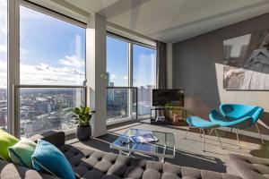 a living room with a couch and chairs and windows at Staying Cool At Rotunda in Birmingham
