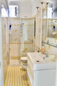 a bathroom with a shower and a sink and a toilet at Guest House Malù in Scala +35 photos
